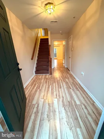 a view of a room with wooden floor and staircase