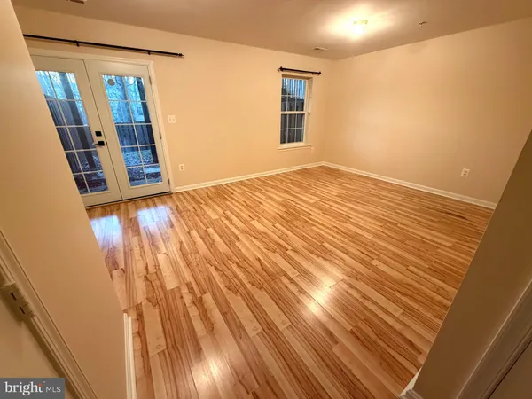 a view of a room with wooden floor