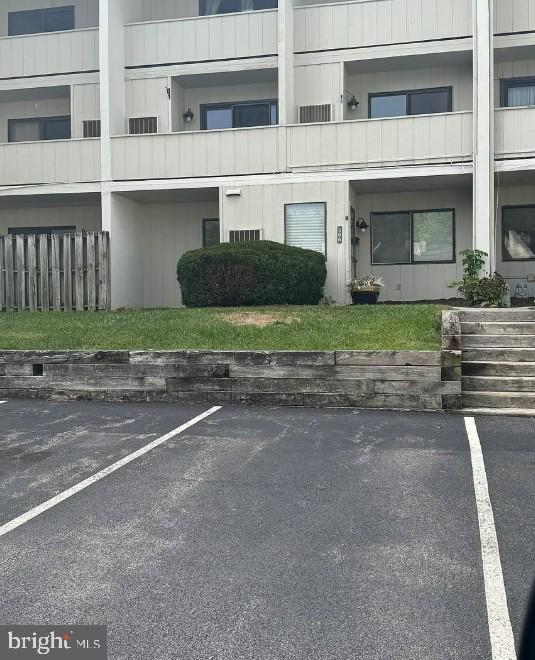 306 Summit House, Unit 306 West Chester, PA 19382 - Photo 2 of 17 a front view of a house with a yard and a garage