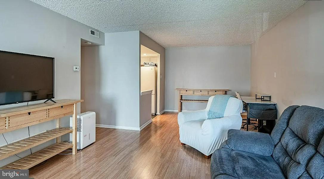 306 Summit House, Unit 306 West Chester, PA 19382 - Photo 5 of 17 a living room with furniture and a flat screen tv
