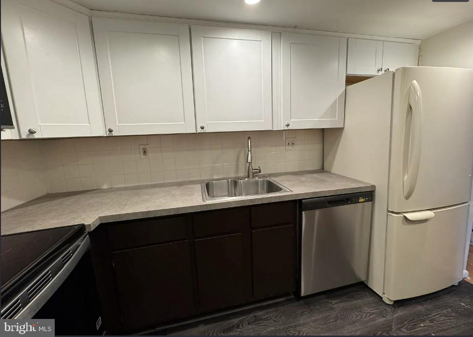 306 Summit House, Unit 306 West Chester, PA 19382 - Photo 9 of 17 a kitchen with stainless steel appliances a refrigerator sink and cabinets