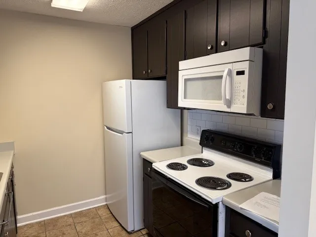 a kitchen with a stove and a microwave