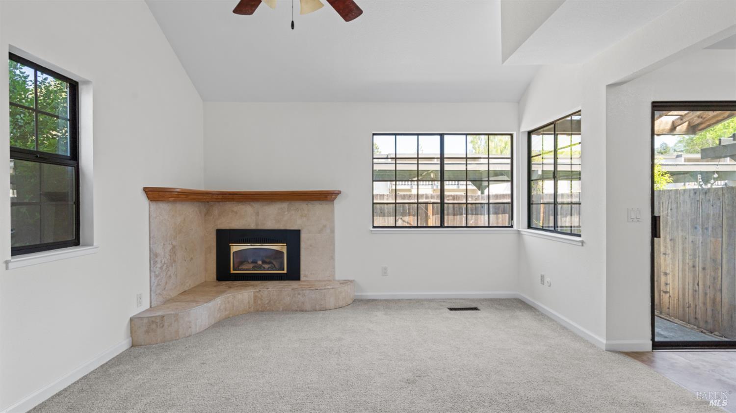 2306 Maher Drive Santa Rosa, CA 95405 - Photo 7 of 28 a view of an empty room with a fireplace and a window