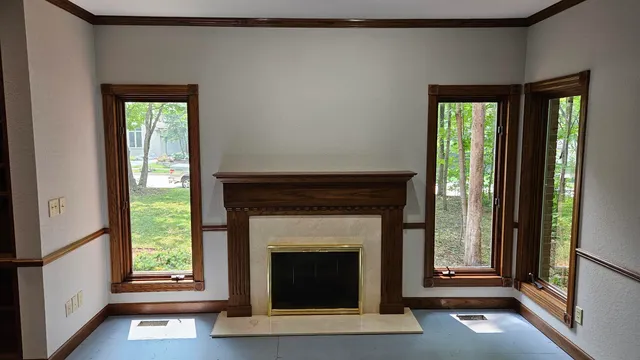 a living room with a fireplace and a window