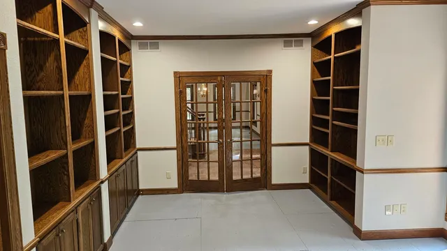 a view of walk in closet with empty racks