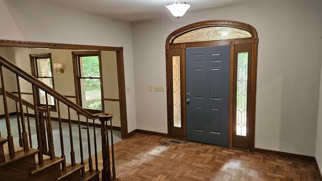 an empty room with windows and chandelier