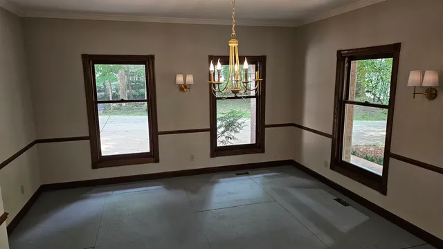 a view of an empty room with window and fire place