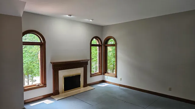 a bathroom with bathtub next to a window