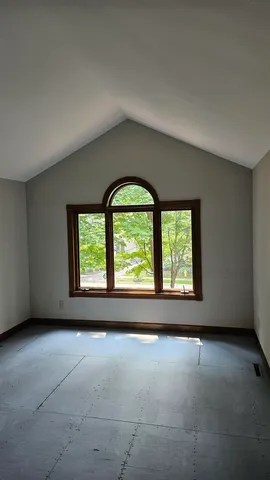 an empty room with windows and outdoor view