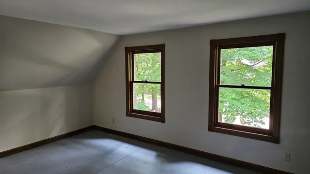 a view of empty room with large windows
