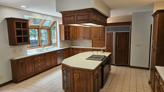 a kitchen with a sink stove and cabinets