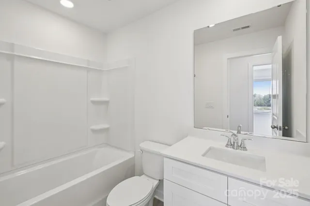 an empty room with closet and a bathroom