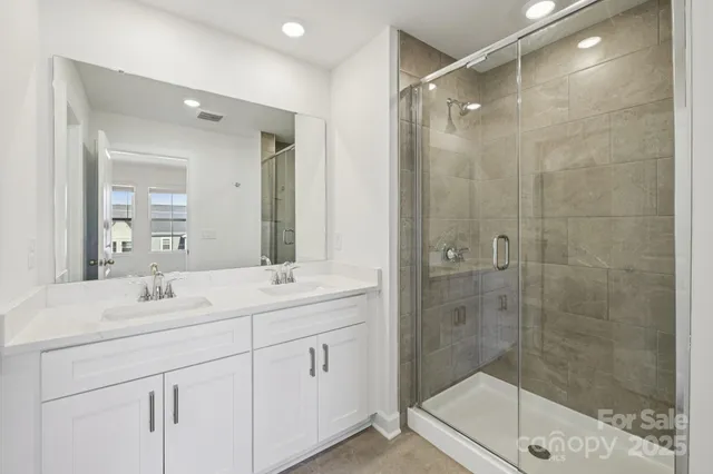 a bathroom with a shower and a sink