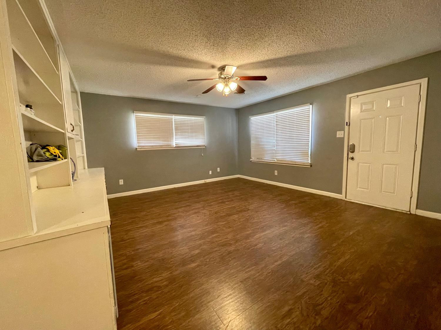 5426 25th Street Lubbock, TX 79407 - Photo 2 of 9 wooden floor in an empty room with a window