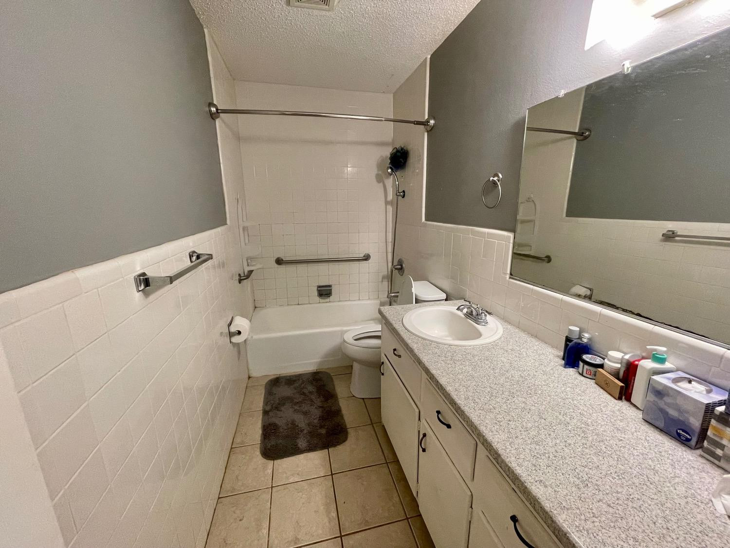 5426 25th Street Lubbock, TX 79407 - Photo 9 of 9 a bathroom with a sink a toilet and shower