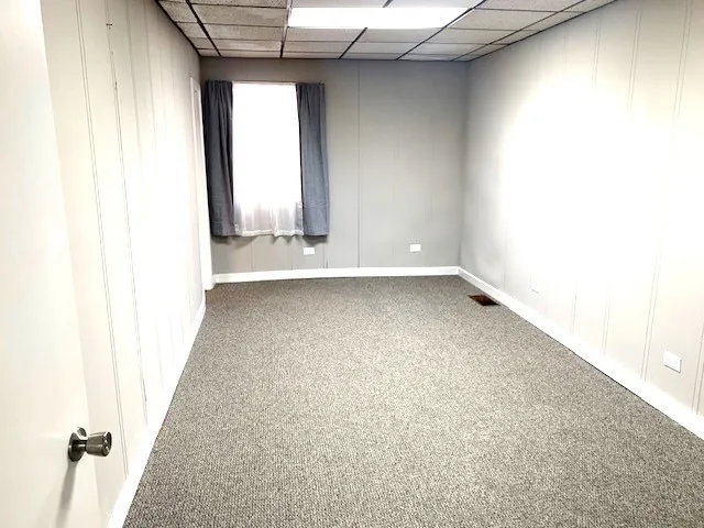 a view of a room with wooden floor and a window