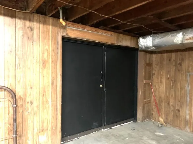 a spacious bedroom with a bed and wooden floor