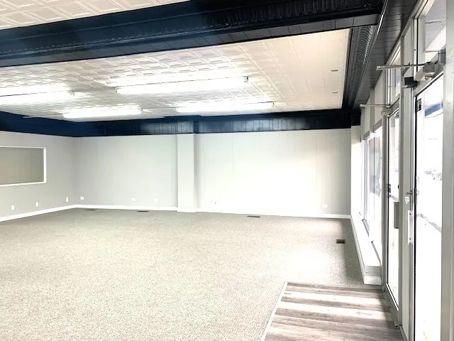 a view of a glass door with wooden floor and a window