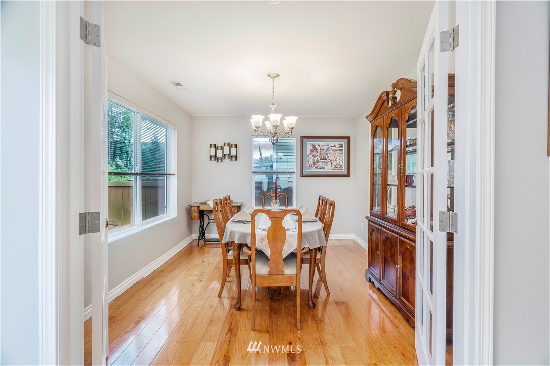 3719 154th Place Southeast Bothell, WA 98012 - Photo 15 of 37 a dining room with furniture a chandelier and wooden floor