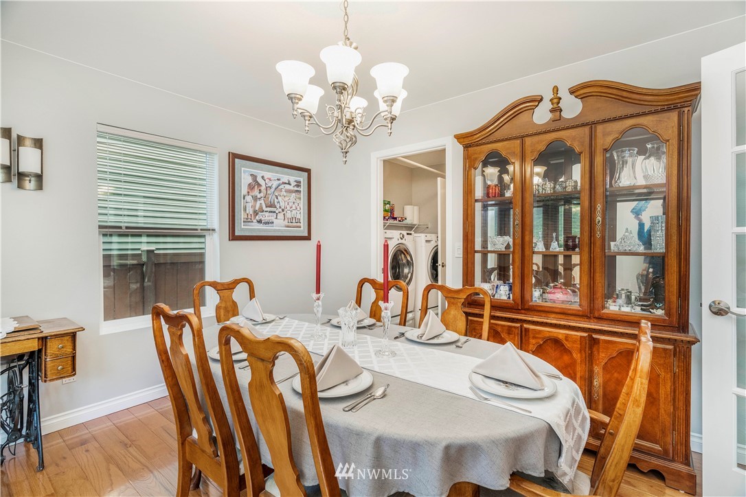 3719 154th Place Southeast Bothell, WA 98012 - Photo 16 of 37 a view of a dining room with furniture wooden floor and chandelier