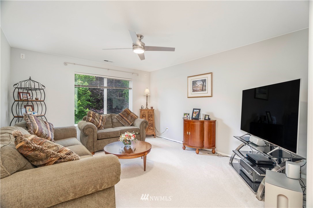 3719 154th Place Southeast Bothell, WA 98012 - Photo 23 of 37 a living room with furniture and a flat screen tv