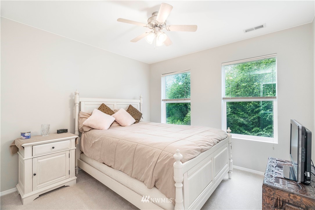 3719 154th Place Southeast Bothell, WA 98012 - Photo 25 of 37 a bedroom with a bed and a flat tv screen on dresser