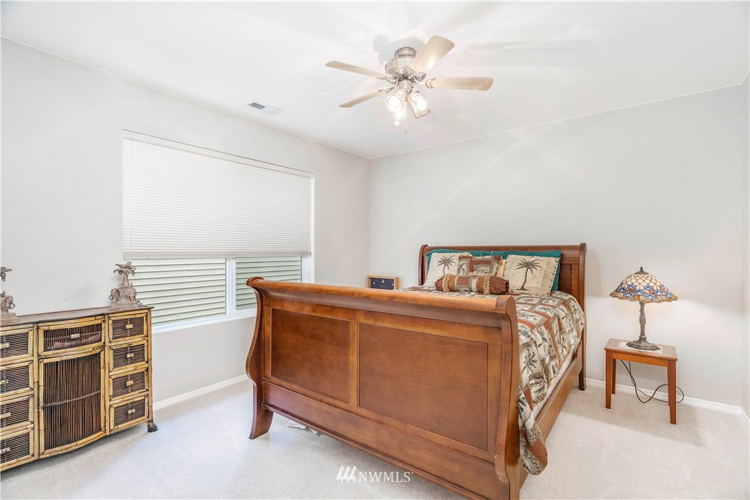3719 154th Place Southeast Bothell, WA 98012 - Photo 27 of 37 a bedroom with a bed and a chandelier
