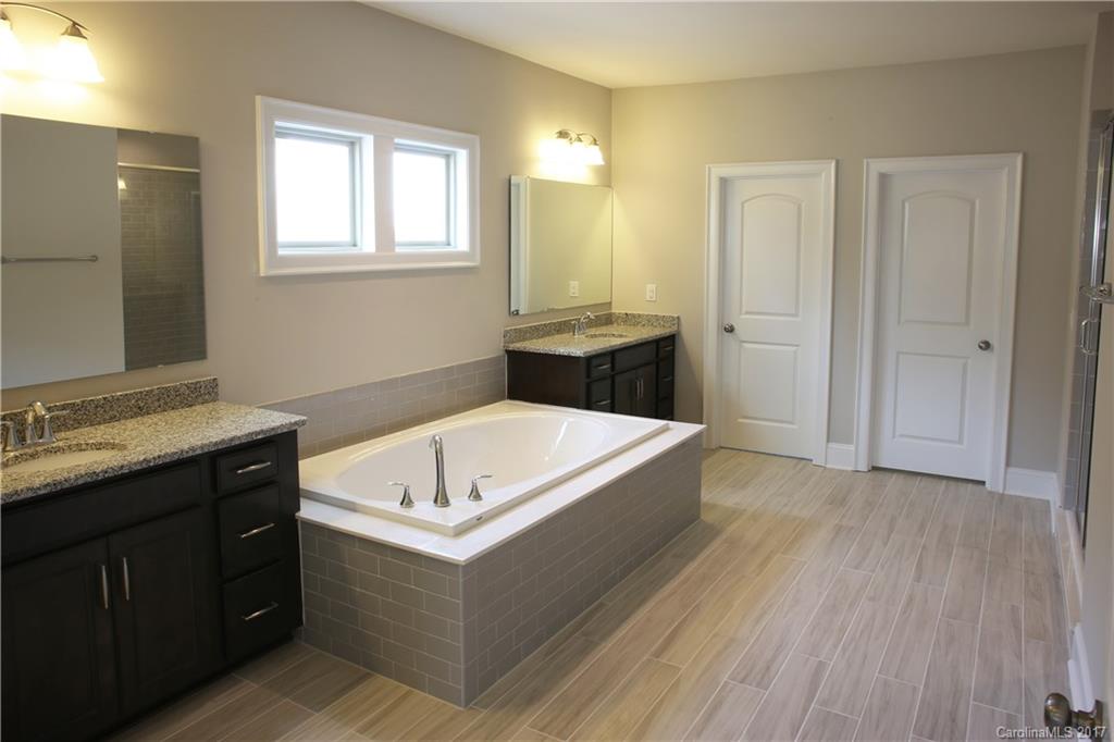 1532 Afton Way, Unit 168 Fort Mill, SC 29708 - Photo 8 of 19 a bathroom with a tub a sink and a mirror