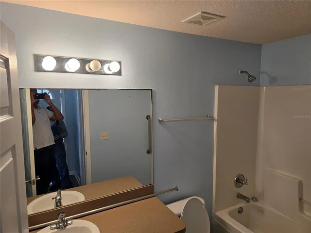 a bathroom with a tub and shower