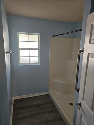 a bathroom with a glass shower door