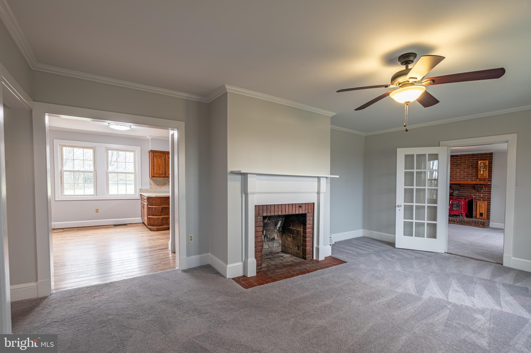 5680 Bryantown Road Bryantown, MD 20617 - Photo 12 of 35 a view of an empty room with chandelier fan and fire place