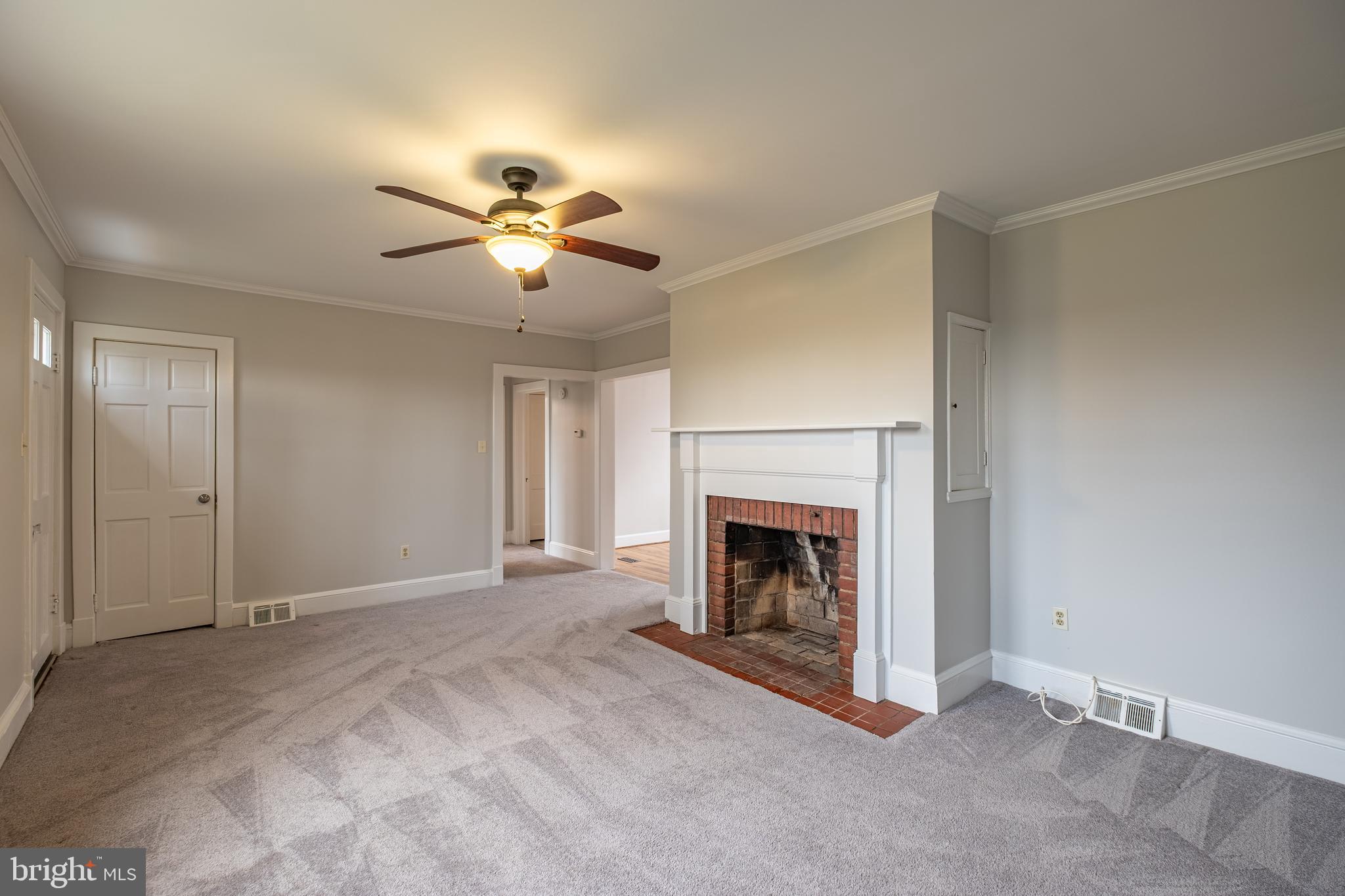 5680 Bryantown Road Bryantown, MD 20617 - Photo 13 of 35 a view of a livingroom with a fireplace and a ceiling fan