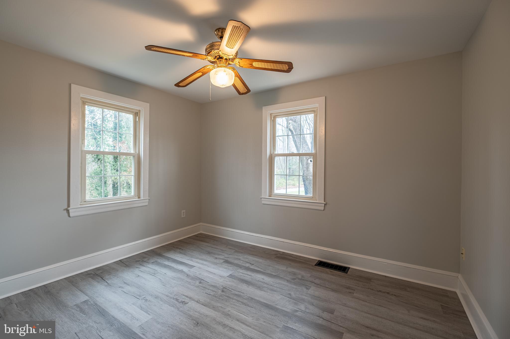 5680 Bryantown Road Bryantown, MD 20617 - Photo 14 of 35 a view of an empty room with wooden floor and a window