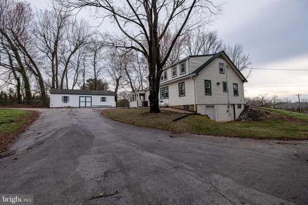 a view of house with a yard