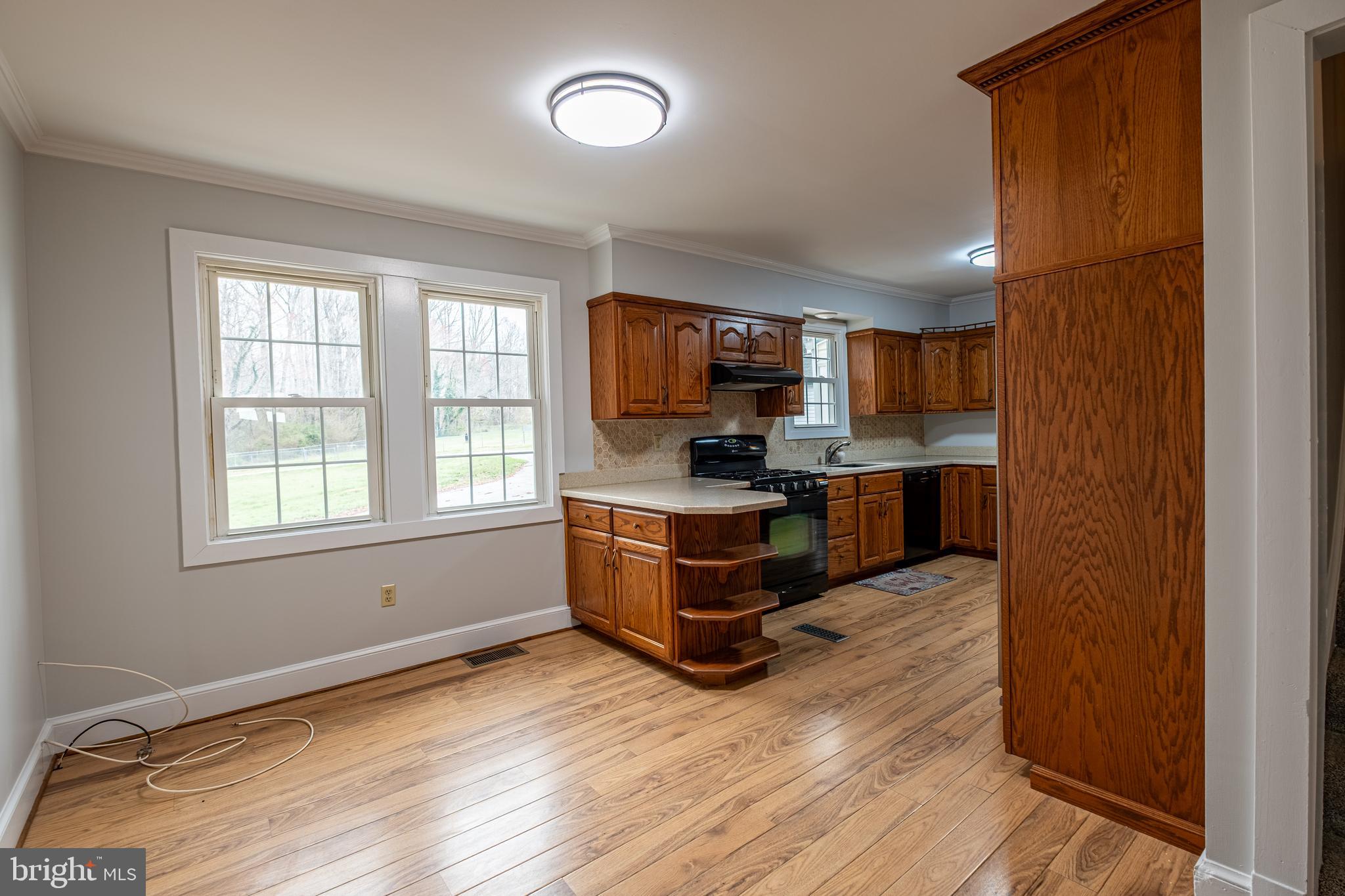 5680 Bryantown Road Bryantown, MD 20617 - Photo 10 of 35 a kitchen with a refrigerator and a stove top oven