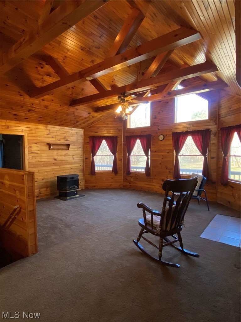 2008 Goose Creek Road Petroleum, WV 26161 - Photo 10 of 35 Sitting room featuring wood ceiling, dark colored carpet, ceiling fan, lofted ceiling with beams, and wood walls