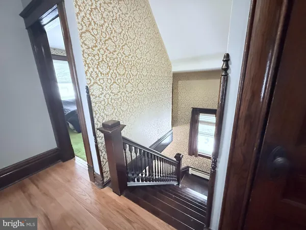 a view of entryway with stairs and wooden floor