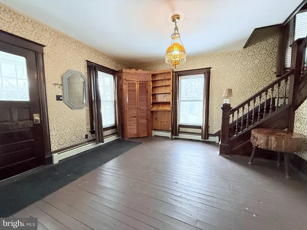 a view of an entryway with wooden floor
