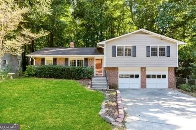 a front view of a house with a yard
