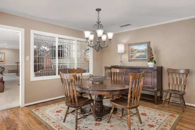 a view of a livingroom with furniture wooden floor and a potted plant
