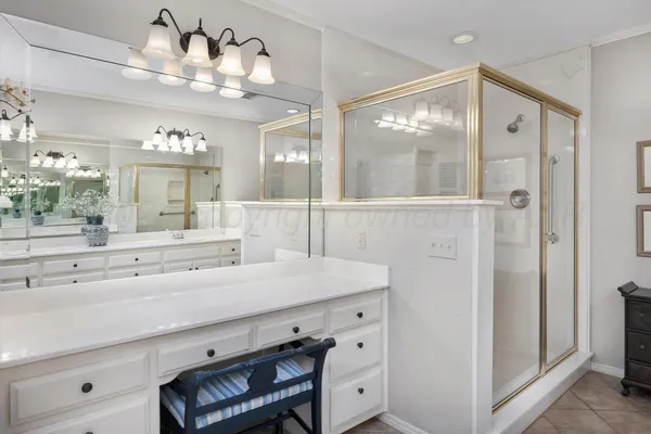a bathroom with a bathtub a sink and a view of bathroom
