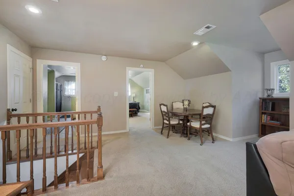 a living room with furniture large window and a lamp