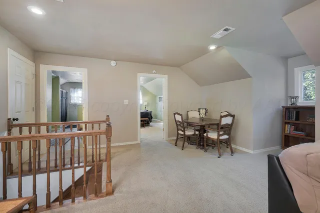 a living room with furniture large window and a lamp