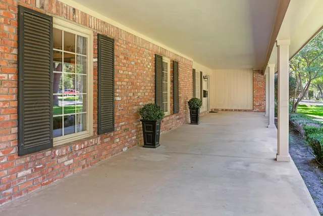 a view of a hallway with a door and wooden floor