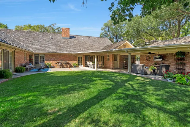 a living room with patio furniture and a flat screen tv
