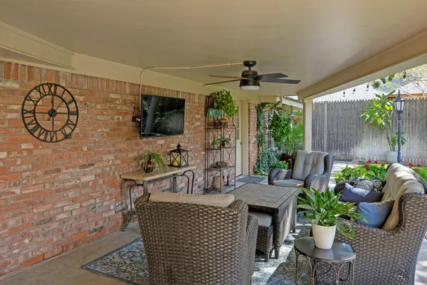 a view of a patio with table and chairs and potted plants