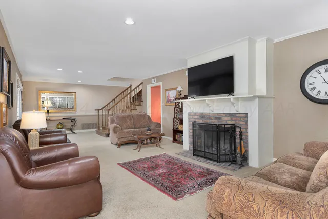 a living room with furniture fireplace and flat screen tv