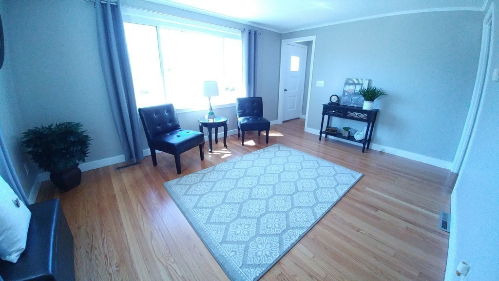 199 Harkness Avenue Springfield, MA 01118 - Photo 4 of 11 a living room with furniture and wooden floor