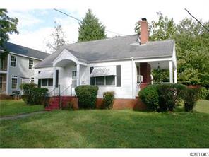 a front view of house with a garden