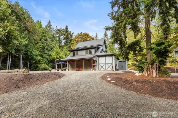 a front view of a house with a yard and trees
